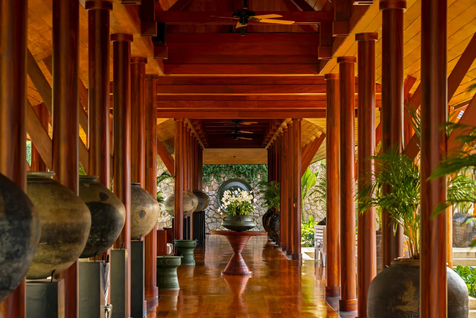 Teak entrance pavilion with antique Thai jars at Chandara Estate