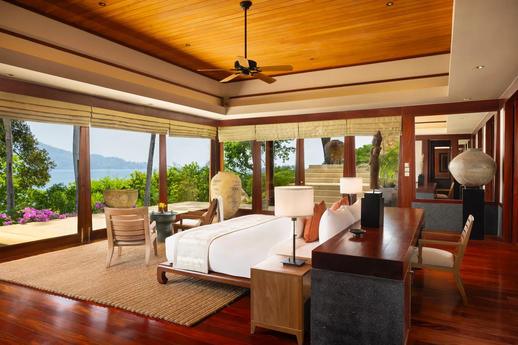 Deluxe ocean bedroom with teak ceiling and views across the bay
