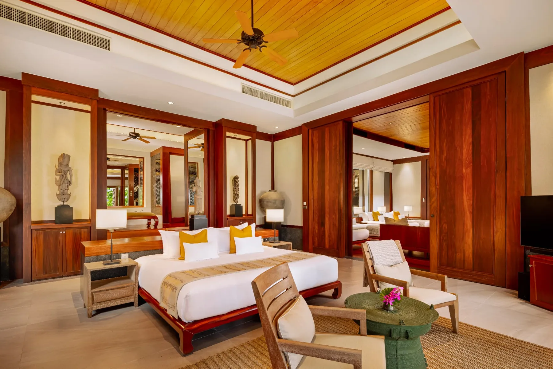 Deluxe ocean view bedroom with teak ceiling and Thai antiques