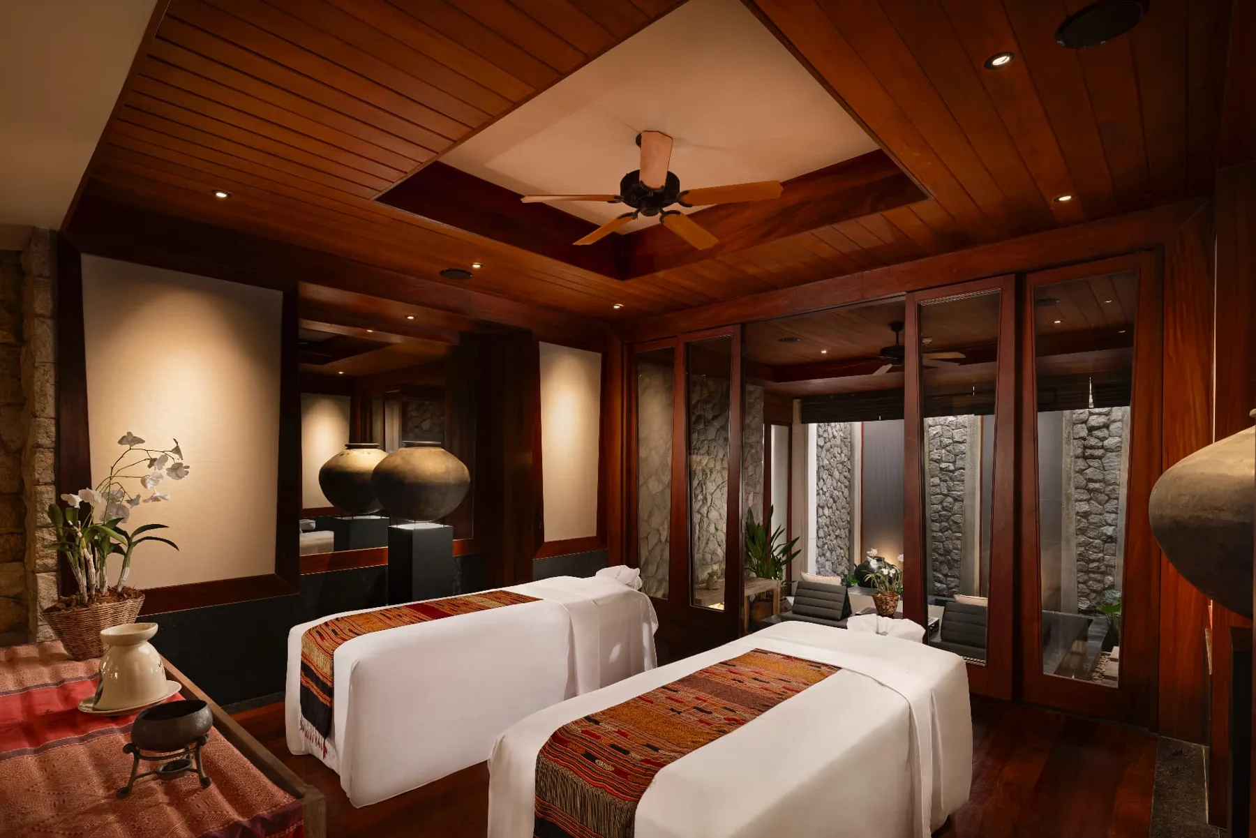 Private spa suite with twin massage beds and teak interiors